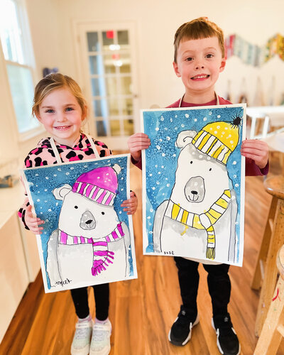 Artcie kids holding paintings of polar bears