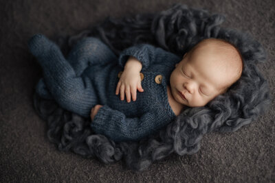 newborn boy holding bear at studio photography 
