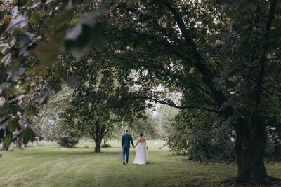 bride and groom walk for photos outside on wedding day in NJ