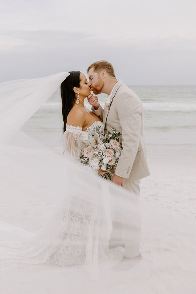 newlyweds kiss on beach