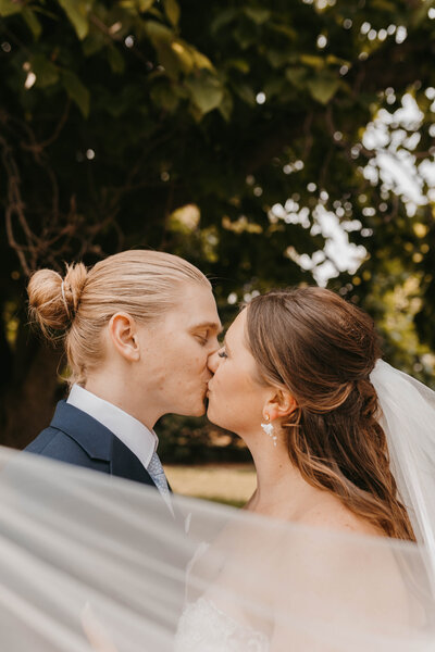 bride and groom kissing on wedding day