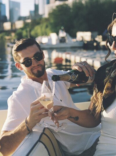 man pouring champagne for fiance