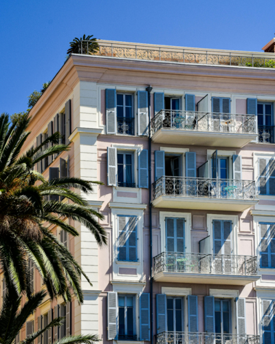 White hotel building in a tropical location, showcasing luxury website design for service-based businesses.