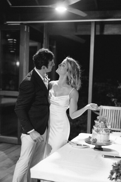 bride and groom portrait enjoying an intimate moment cutting a small cake after their intimate wedding ceremony at Secret Bay, Dominica captured by Asia Pimentel Photography