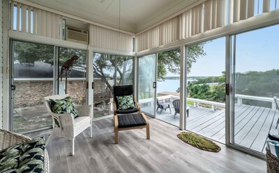 Enclosed porch with view of the lake at this 3-bedroom, 2.5 bathroom lake house with incredible view of Lake Belton located at Morgan's Point, near Rogers Park and Temple Lake Park.