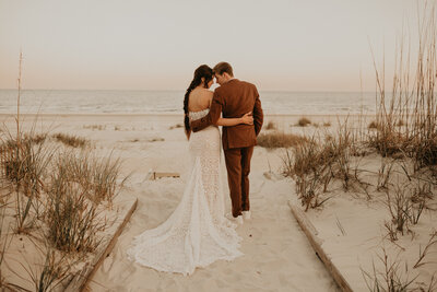 bride and groom posing on beach