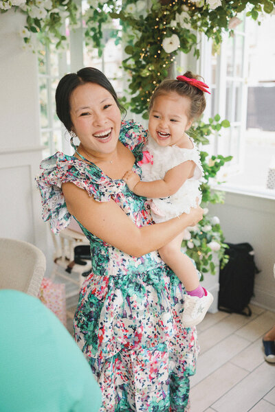 a mom holding her toddler daugther