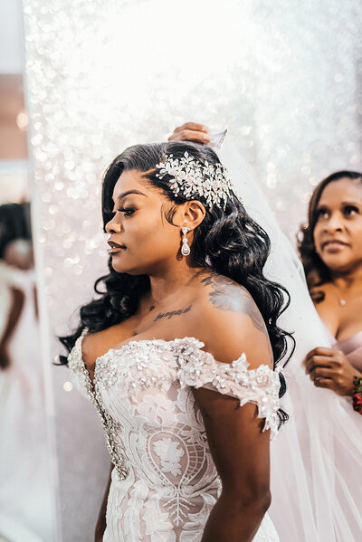 bride with long hair getting ready with the mother of the bride