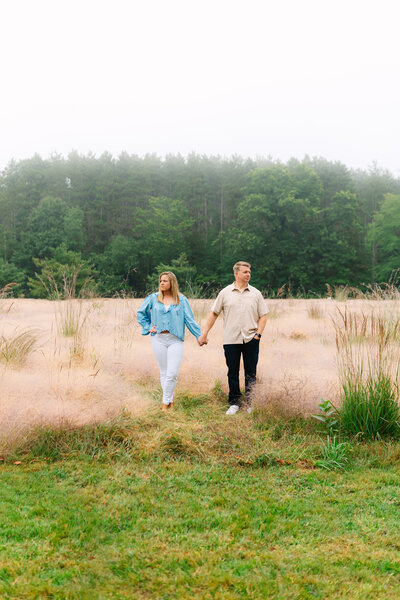 couple in a field with foggy background
