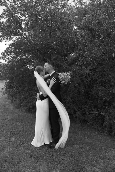 Maine couples embraces under trees