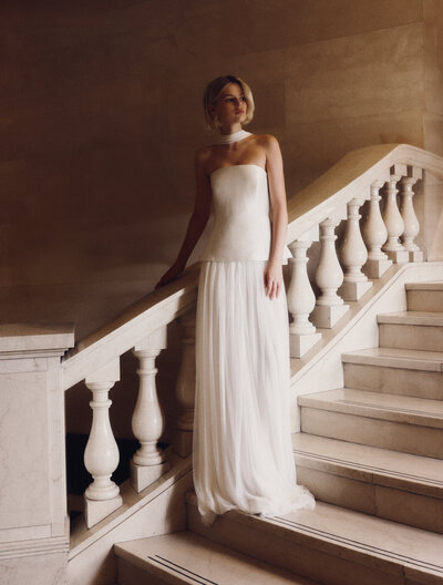 black and white image bride wearing strapless satin wedding dress with long train
