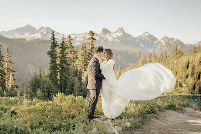 couple kissing on their car in the woods