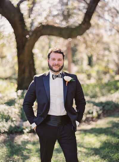Southern groom wearing a black tux and Brackish bow tie