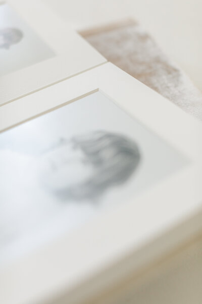 Framed, matted black and white portrait of a toddler from a Kansas City milestone session, printed as fine art for display in the home.