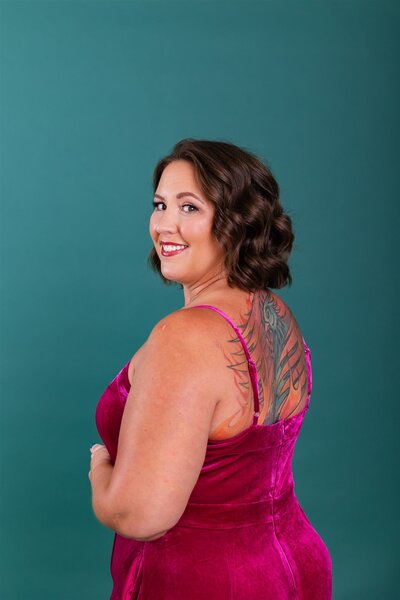 Life transitions therapist smiling in a pink jumpsuit