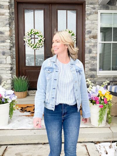 Kati standing in front of her  home