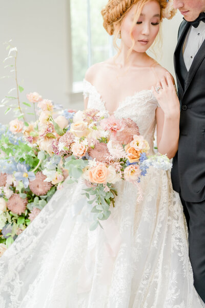 Beautiful Asian bride with big bouquet in the Park Chateau wedding chapel