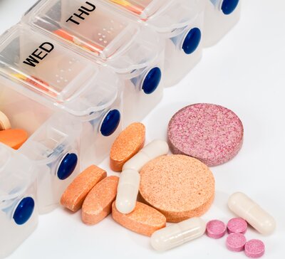 multi colored pills and drug box Weds Thurs