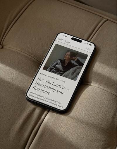 Mockup of an iPhone displaying a a beautiful meditation teacher's website design