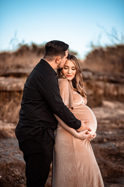 Mom and dad posing for pregnancy photos