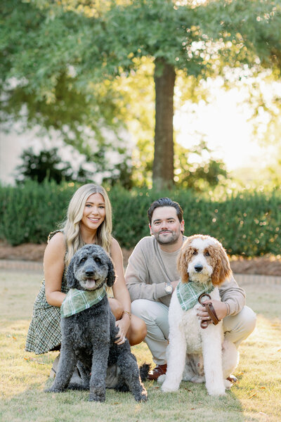 Couple smiling with their dogs in a park