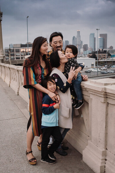 Asian family hugging on Fourth Street bridge in DTLA
