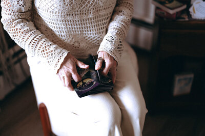 Janna Weldum of Eagle's Guiding Light sits in a chair shuffling oracle cards at The Eyrie.