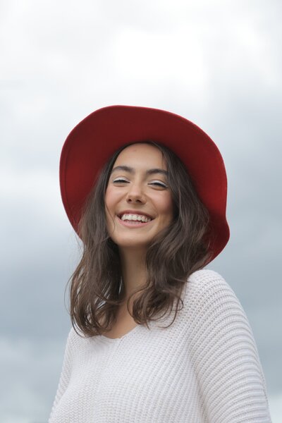Woman with red hat smiling