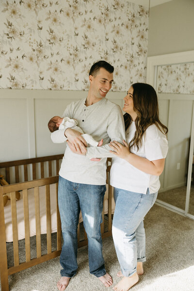 parents sitting on a blanket holding their baby