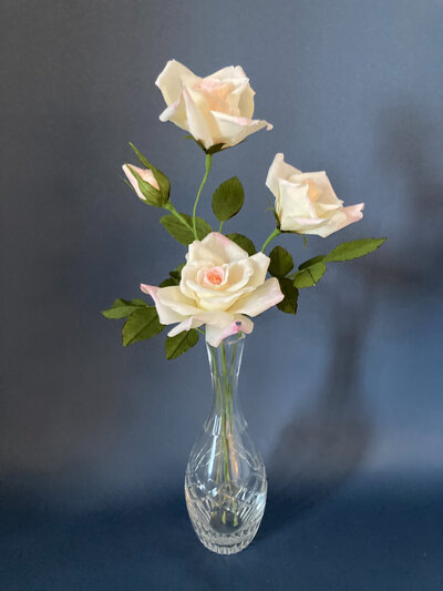 Cream roses in paper