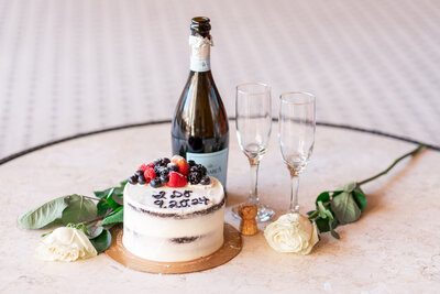 Wedding cake detail with wine and wine glasses at the Driskill Hotel in Austin Texas.