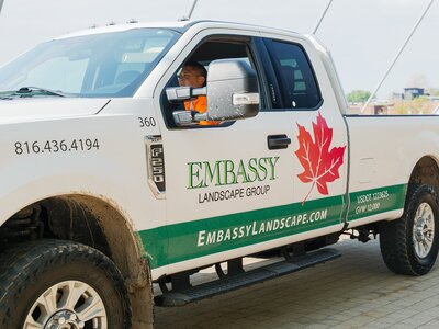 A side view of an Embassy Landscape Group truck