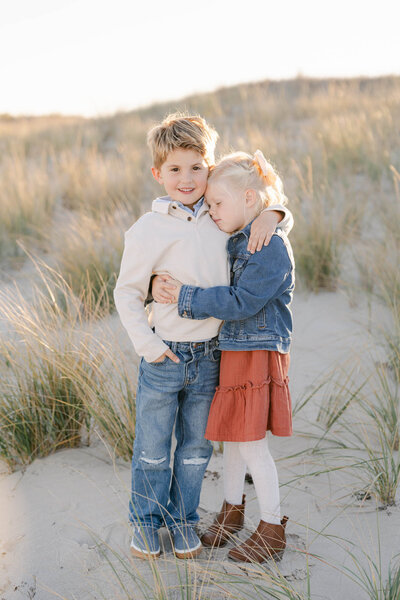 Family of five walks a sandy path