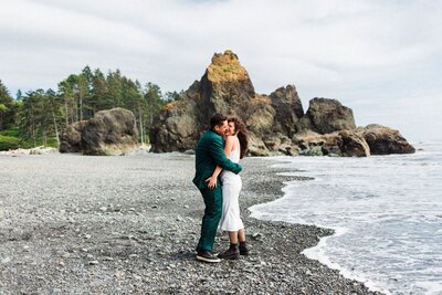 a couple cuddling on Ruby Beach during their Olympic National Park Elopement