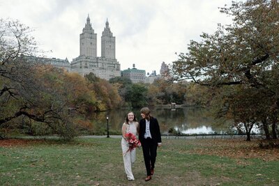 autumn central park elopement couple on cherry hill with the lake and dakota in the background