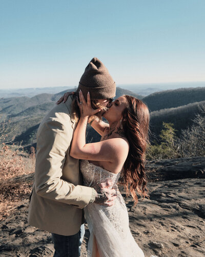 Eloping couple kissing on their wedding day