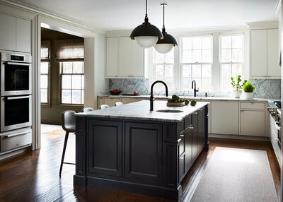 A modern outdoor kitchen in a new construction pool house with custom kitchen cabinets in Boston, light grey cabinetry, and a Sub-Zero glass door refrigerator.