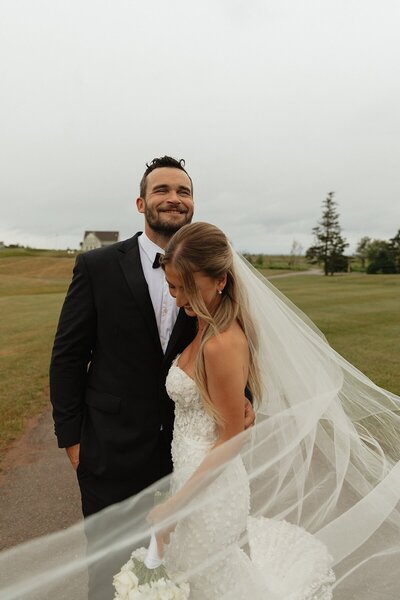 bride and groom posing for wedding photos at prince edward island