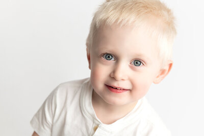 Captured in a bright and simple setup, this toddler milestone portrait radiates happiness and the charm of early childhood.