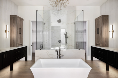 Marble backsplash by Vadara, glass shower, white cabinets