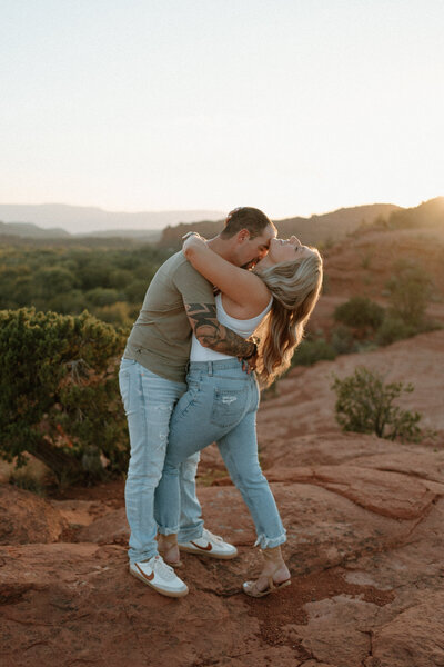 a couples in sedona surrounded by red rocks