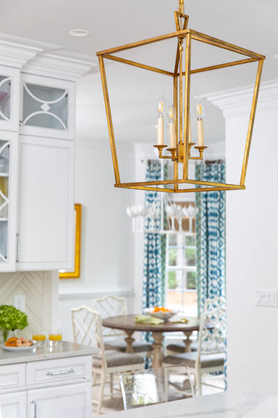 Bright kitchen with gold lighting fixture