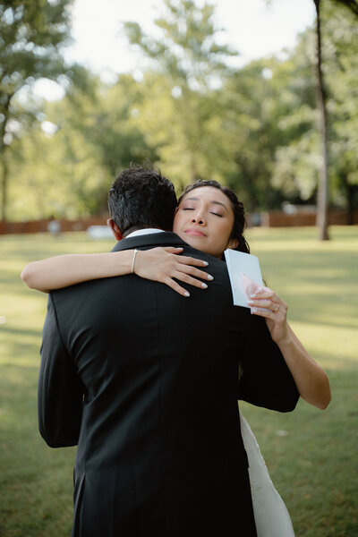 Emotional photo of Bride hugging her groom after reading their private vows