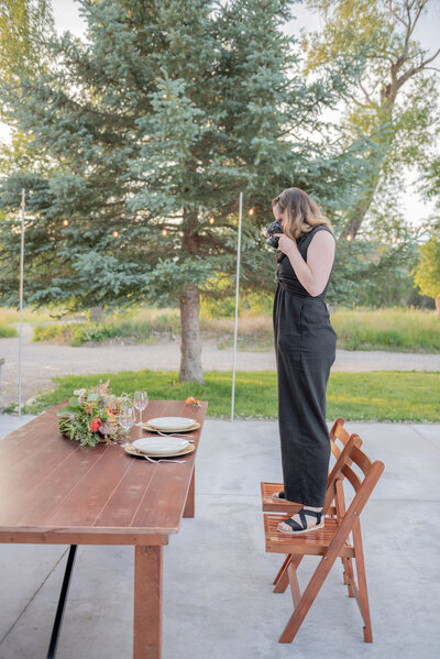 Idaho wedding photographer captures woman standing on chair taking photos