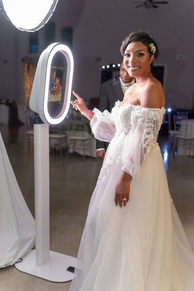 A bride using the Dallas Fort WOrth Photo Booth at her wedding.