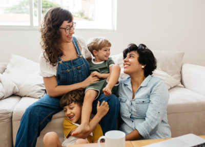 Parents and children sitting on the couch together