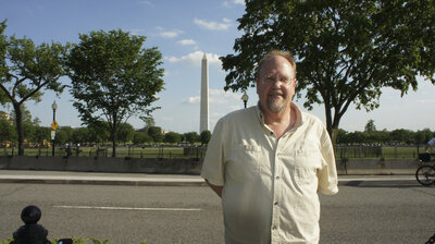 Photographer Fred W. Gillaspy in Washington, DC with Washington Monument in background.