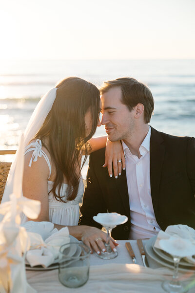 Sunset portrait of the bride and groom embracing against a stunning coastal backdrop, captured by a La Jolla wedding photographer.