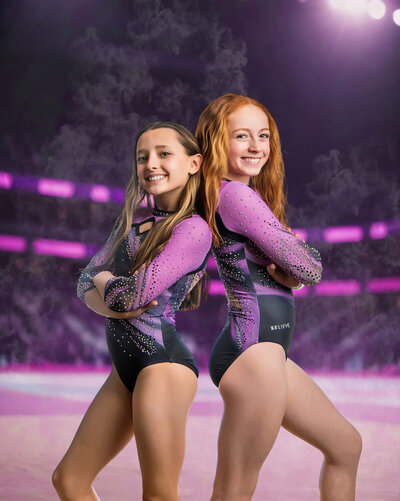 two young gymnasts posing back to back on a digital backdrop of a smokey gymnastics competition stadium