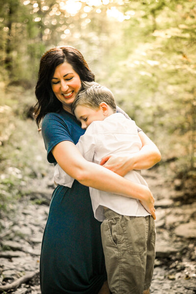 mom and son hugging blue flowy short sleeve dress creek mini